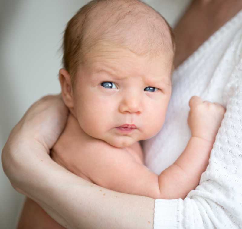 Newborn baby being held